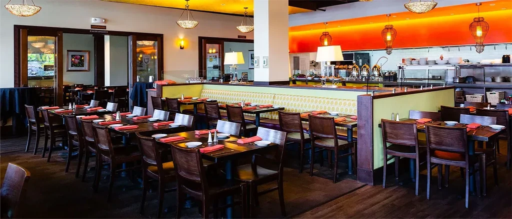 Dining area of a modern restaurant with tables, chairs, and booths.