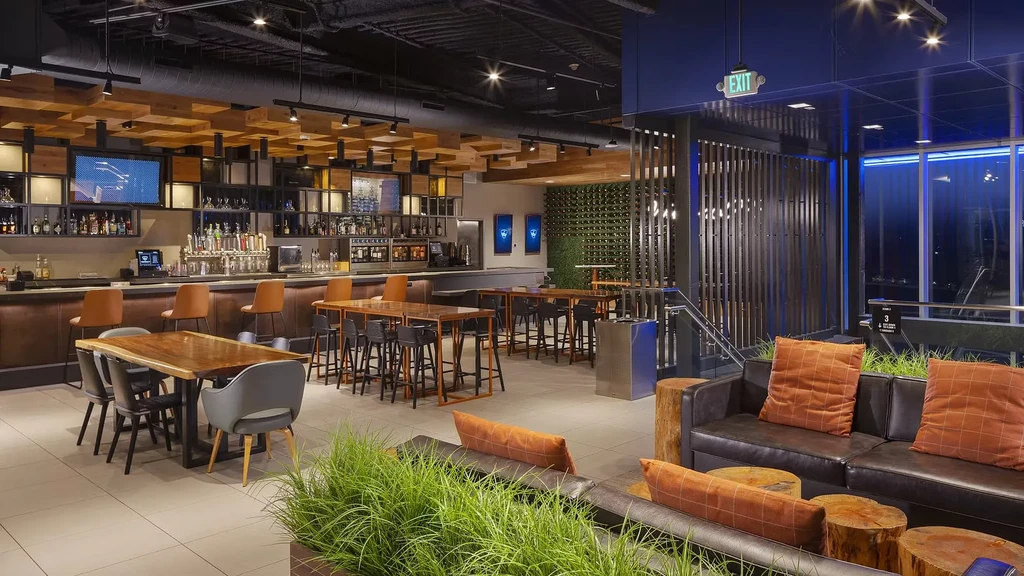 Stylish modern bar and lounge with diverse seating and cityscape.