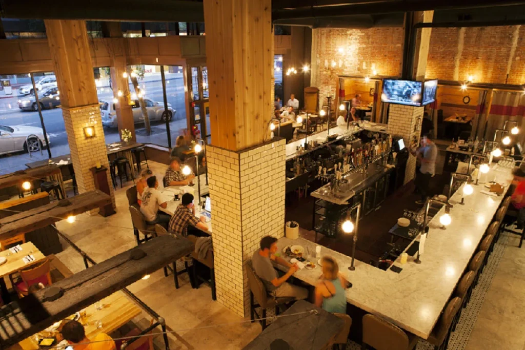 High-angle view of a restaurant interior with patrons and a bar.