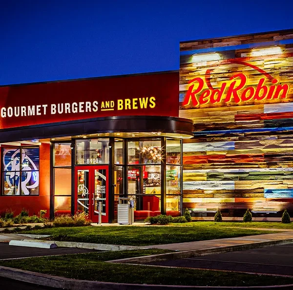 Red Robin restaurant exterior at night, with illuminated logo and text.