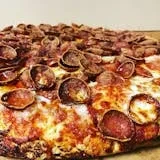 A whole pepperoni pizza topped with chocolate cereal.