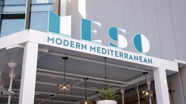 The sign for "MESO Modern Mediterranean" restaurant with teal lettering.