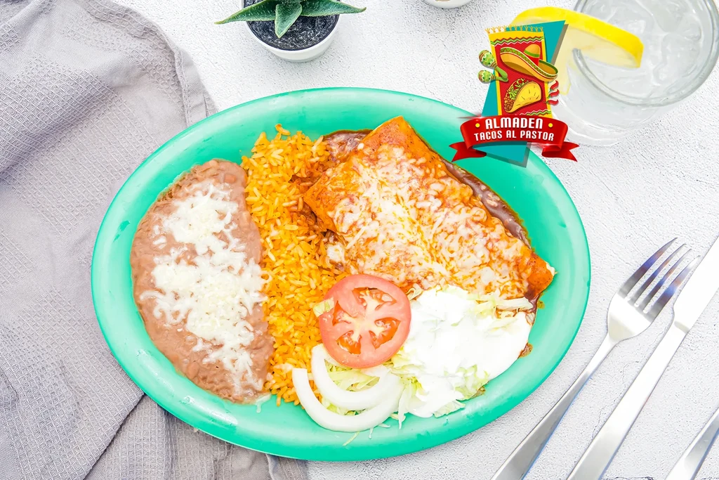 A plate of enchiladas, rice, and refried beans with cheese.