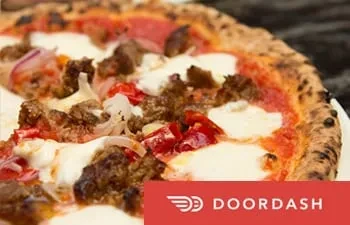 A delicious Neapolitan-style pizza with pepperoni, sausage, peppers, onions, and mozzarella.