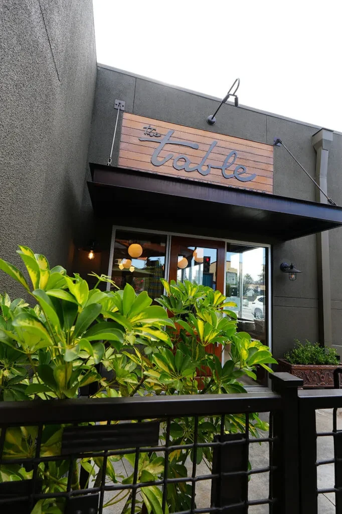 The "The Table" restaurant sign is visible above its glass entrance.