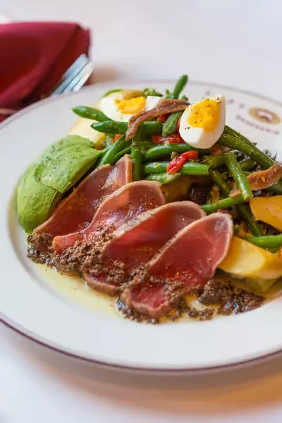 Salad Niçoise with seared tuna, green beans, avocado, and hard-boiled eggs.