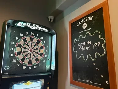 Electronic dartboard and chalkboard sign with Jameson and 'greeN teas'.