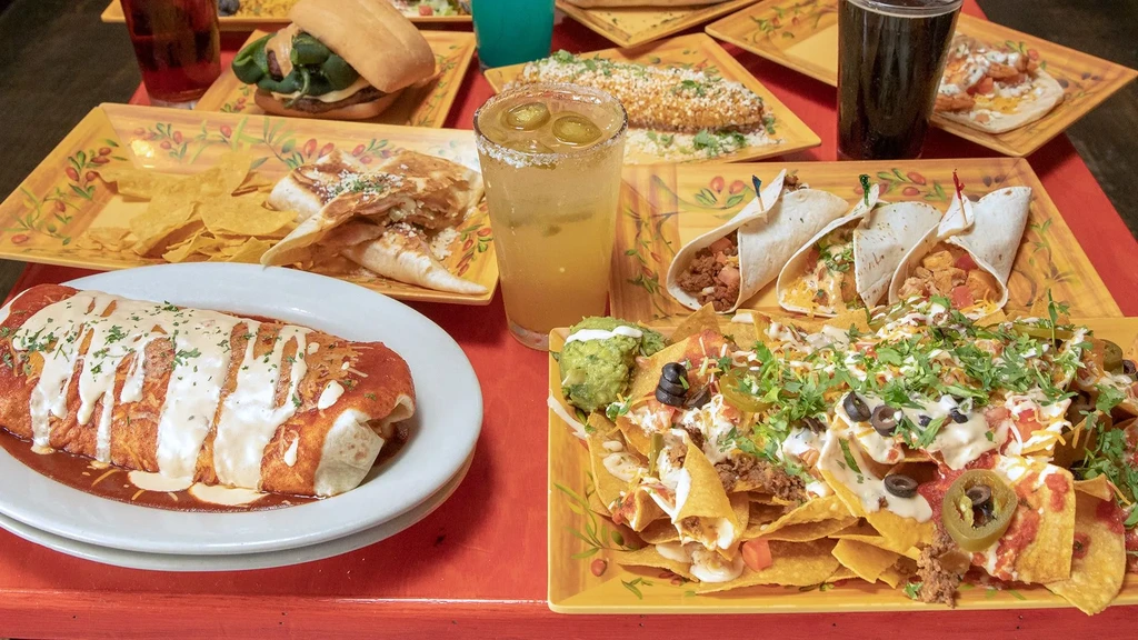 Overhead view of a large spread of Mexican food and drinks.