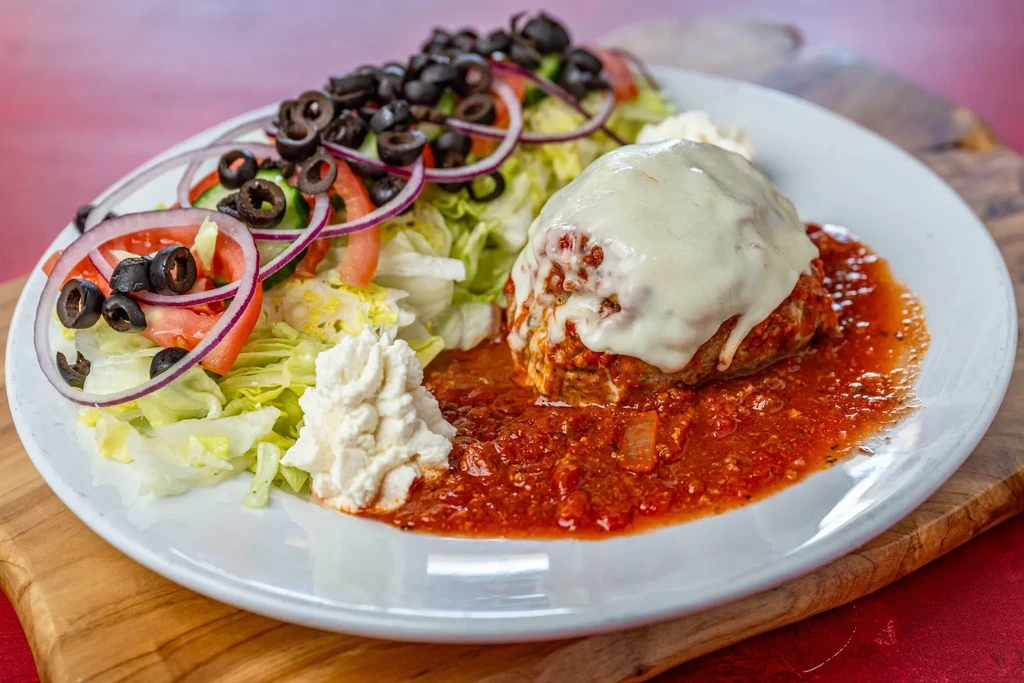 Cheesy chicken or meat dish, red sauce, side salad, and ricotta.