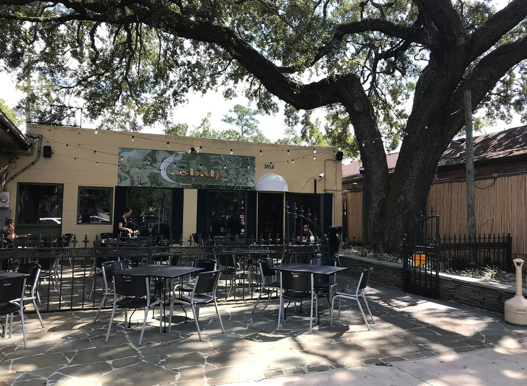 Exterior of Asbah Cafe with large tree shading its patio.