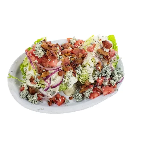 Crisp iceberg wedge salad with blue cheese, bacon, tomatoes, and onions.