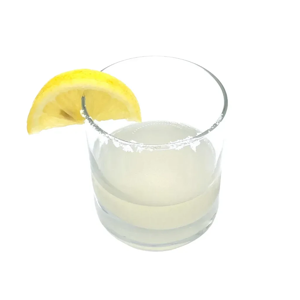 Glass with light drink, salted rim, and lemon wedge garnish.