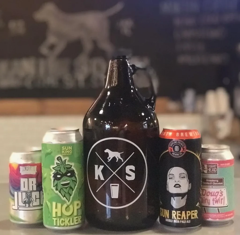 Dark growler with logo flanked by colorful craft beer cans.