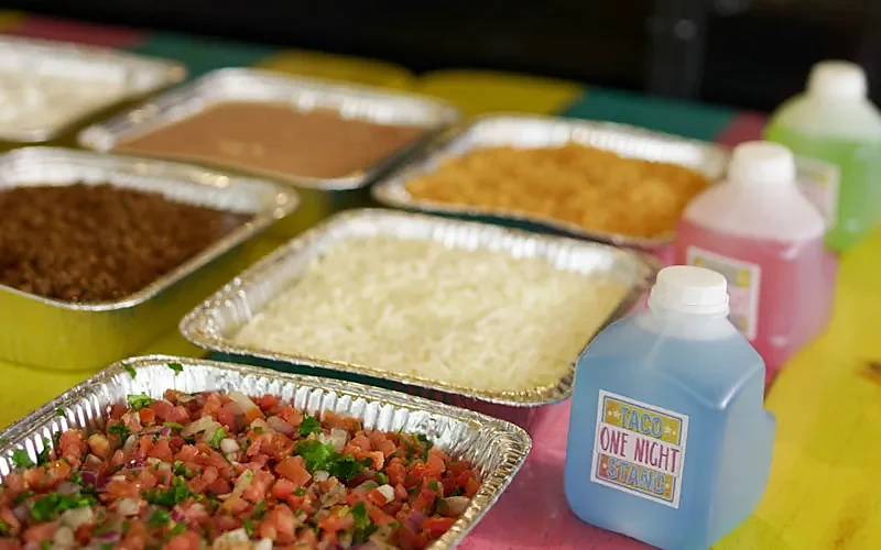 Catering trays of rice, beans, pico de gallo with margarita jugs