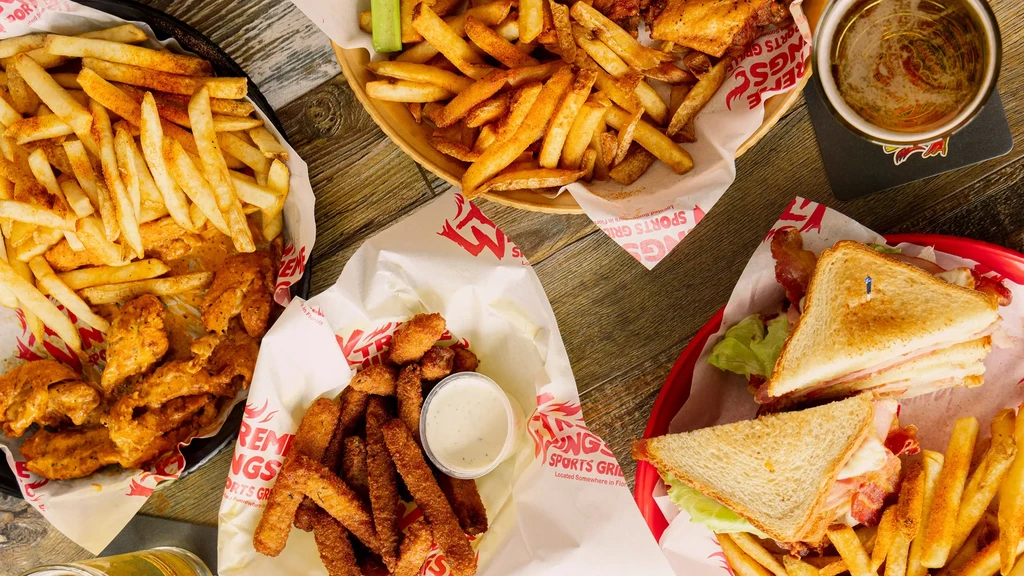 XTREME WINGS SPORTS GRILL: wings, fries, club sandwich, pickles, and beer.