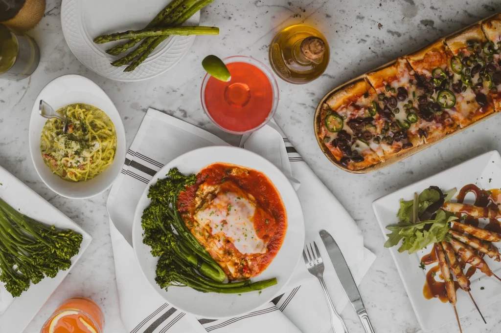 Overhead view of diverse food and drinks on a marble counter.