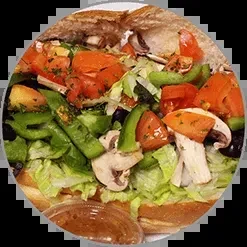 Loaded sub sandwich with lettuce, tomatoes, mushrooms, and peppers.