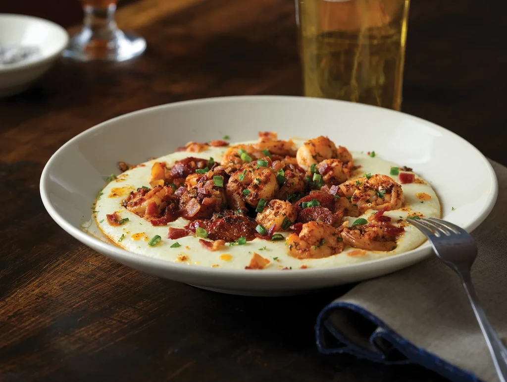 Creamy shrimp and grits with bacon, green onions, and red spices.