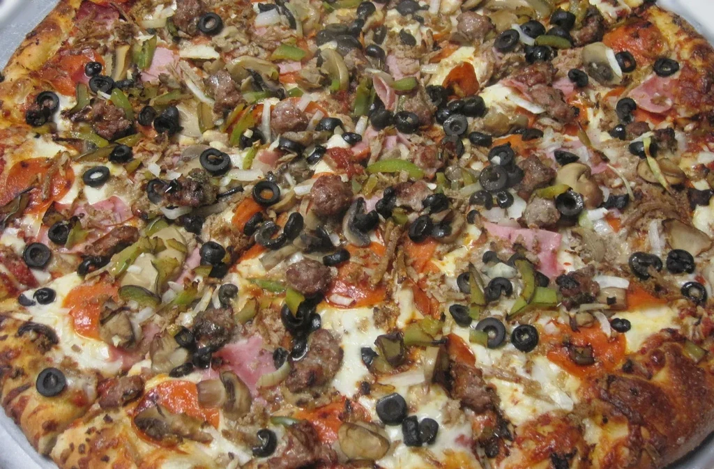 Generously topped pizza with pepperoni, sausage, ham, olives, peppers, onions, mushrooms.