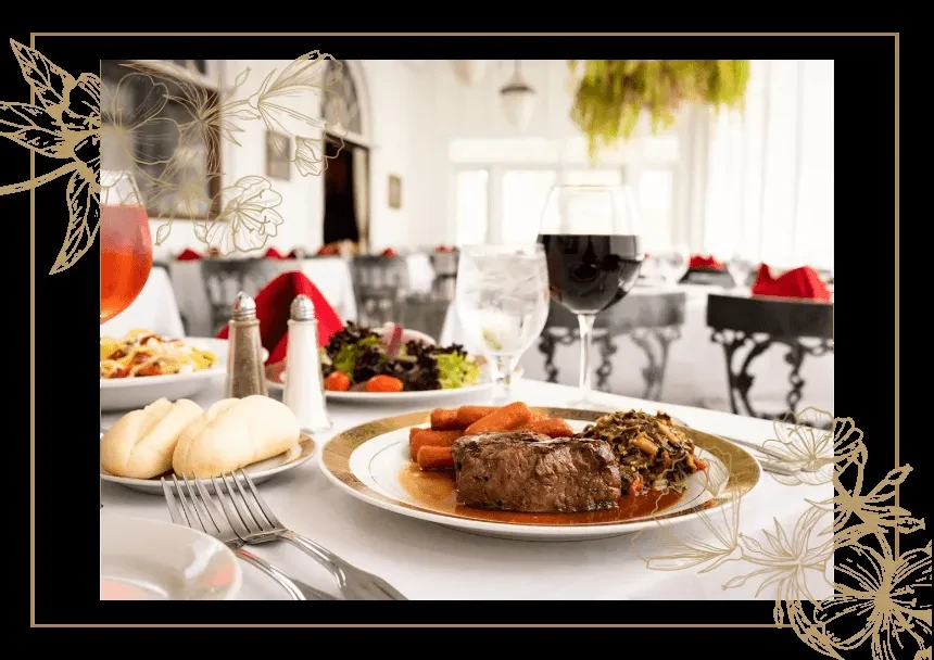 Cooked steak with sides, salad, bread, and wine in an upscale restaurant.