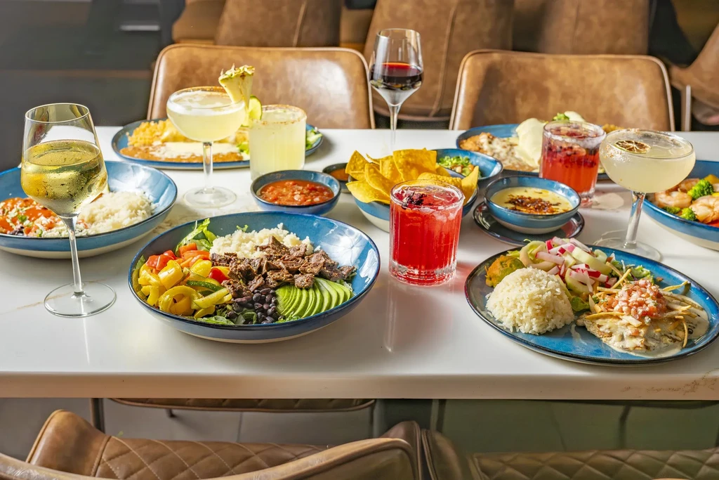 Professionally arranged restaurant table with diverse dishes and drinks.