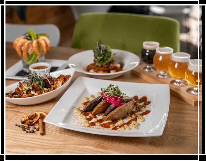 A spread of gourmet food, shrimp cocktail, and a craft beer flight.
