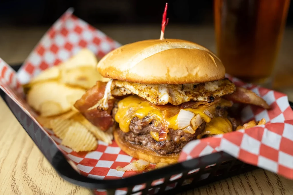 Double cheeseburger with egg, bacon, caramelized onions, and crinkle fries.