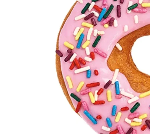 Cropped donut with pink icing and colorful elongated sprinkles.