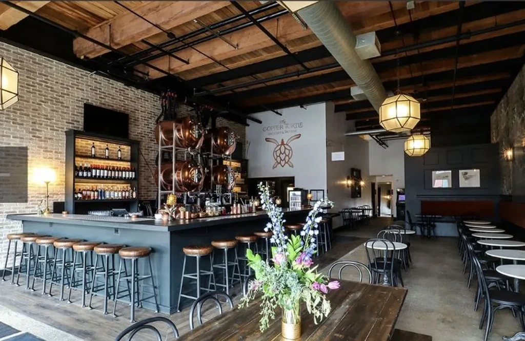 The Copper Turtle Brewery interior with bar, dining, and copper tanks.