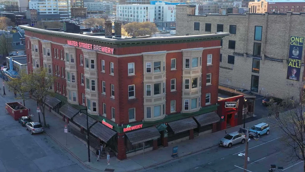 Urban street corner with Water Street Brewery and Elwood's Liquor.