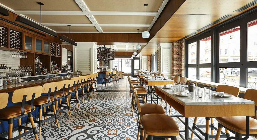 Sleek, modern restaurant interior with a well-stocked bar and dining area.