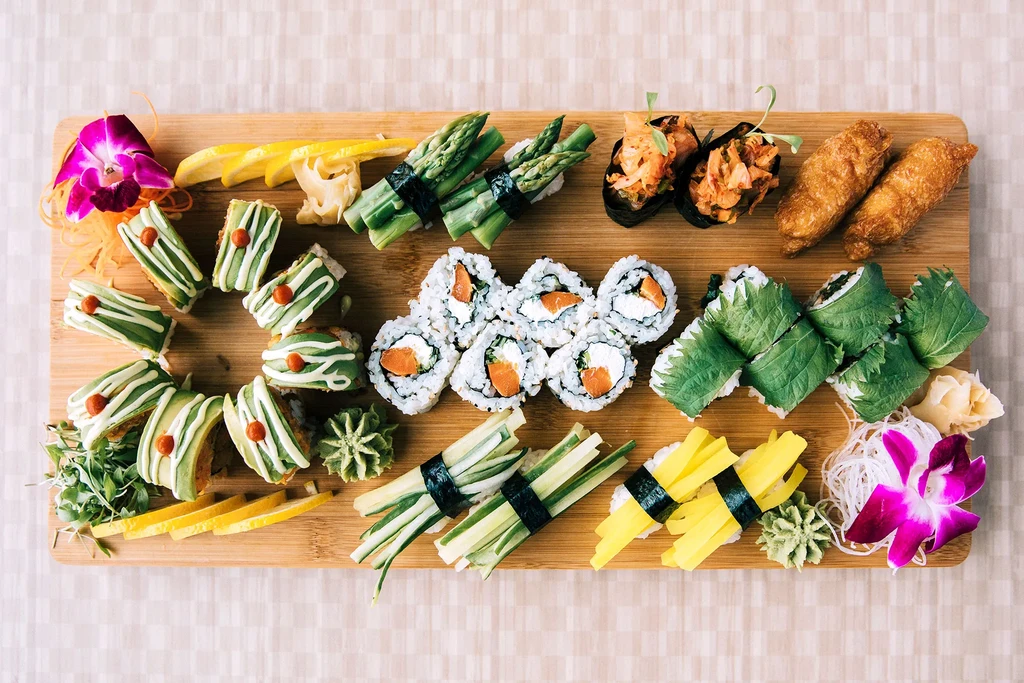 Vibrant, artfully arranged platter of diverse sushi and Japanese appetizers.