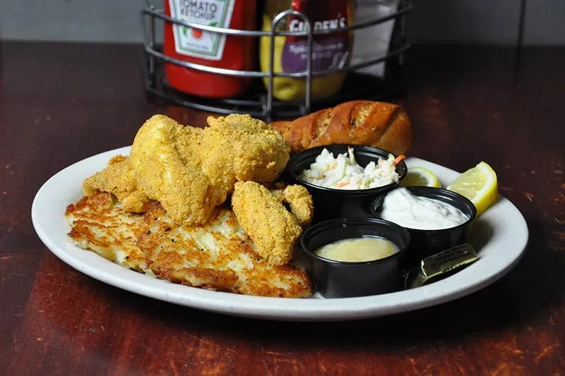 Golden fried fish/chicken, crispy potato pancakes, coleslaw, and sauces.