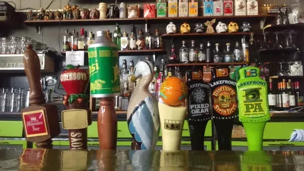 Close-up of a vibrant bar counter featuring distinct beer taps.