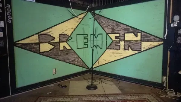 Mint green wall mural with 'BREMEN' and microphone stand.