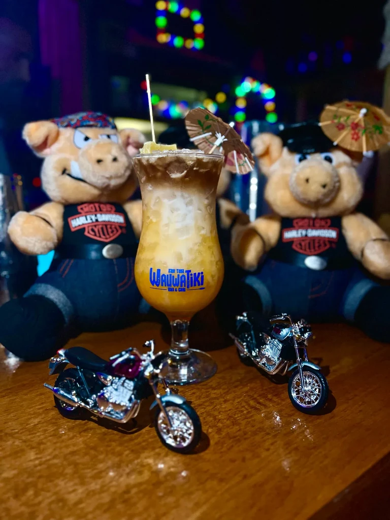 WAUWATIKI BAR & CAFE cocktail, Harley-Davidson pigs, and model motorcycles.