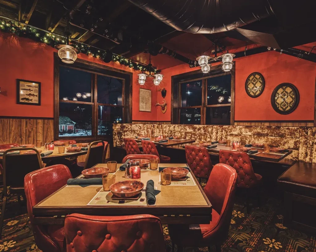 Warm, rustic restaurant interior with red walls and industrial details.