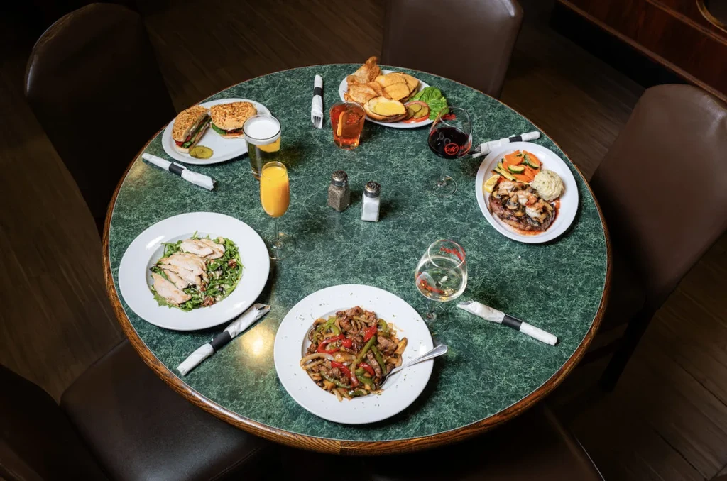 Overhead view of a restaurant table with various dishes and drinks.