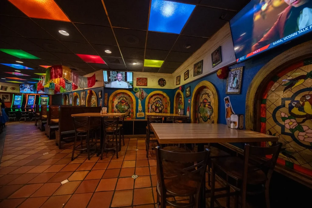 Colorful Mexican restaurant interior showcasing vibrant decor and entertainment options.