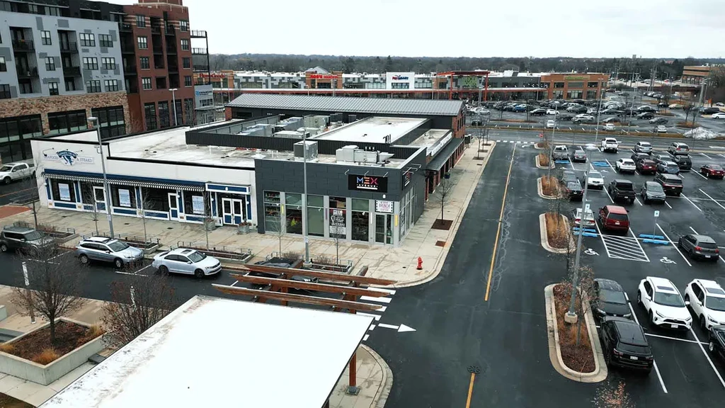 Aerial view of commercial strip mall with Rock & Reilly's and MEX Cocina.