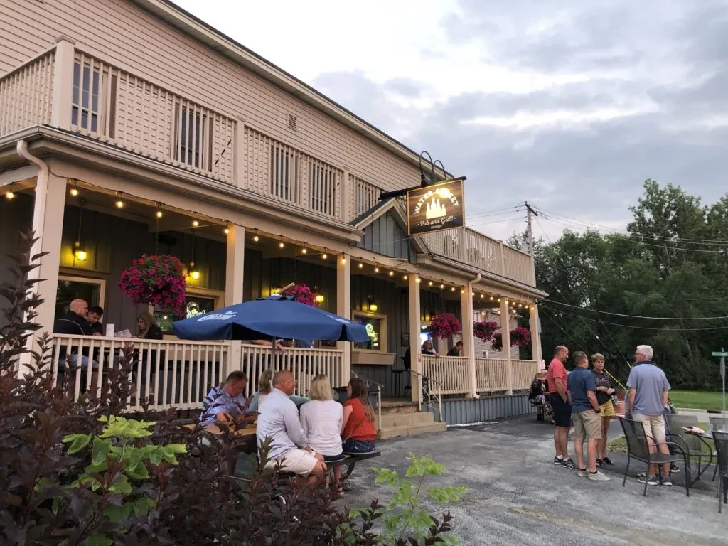 Water Street Pub and Grill's outdoor patio with people at dusk.