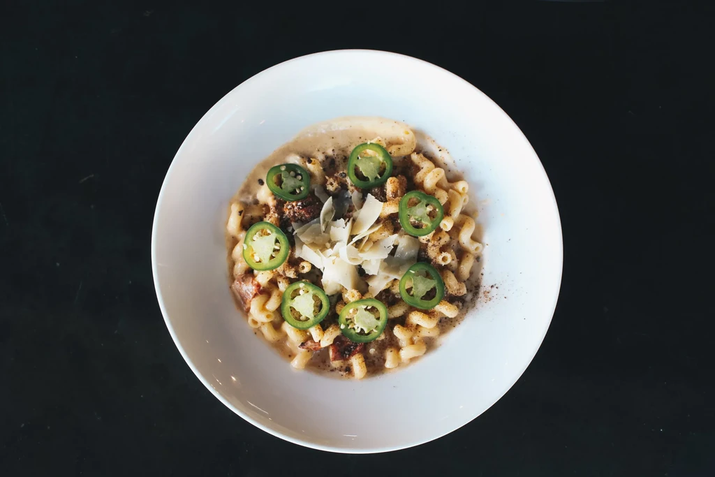 Creamy cavatappi macaroni and cheese with jalapeños and shaved cheese.