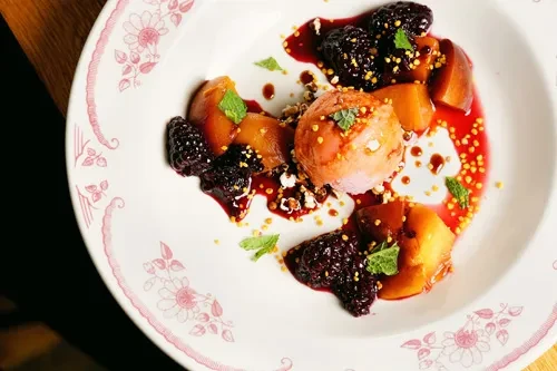 Pink sorbet, caramelized fruit, blackberries, red sauce, and mint.