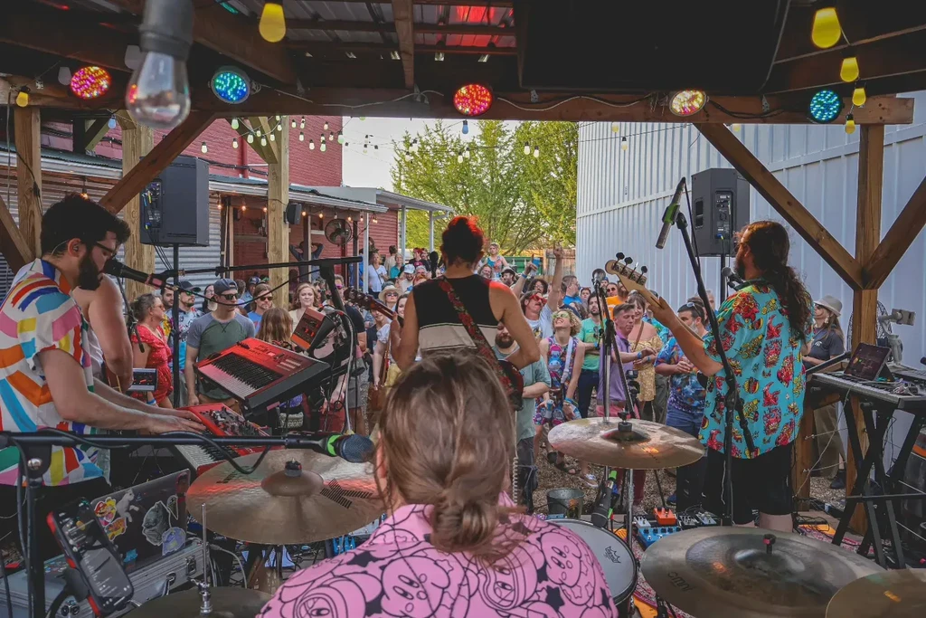 Live band performs for an engaged crowd at an outdoor venue.