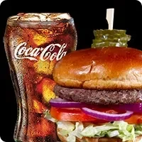 A classic burger and a glass of Coca-Cola on black background.