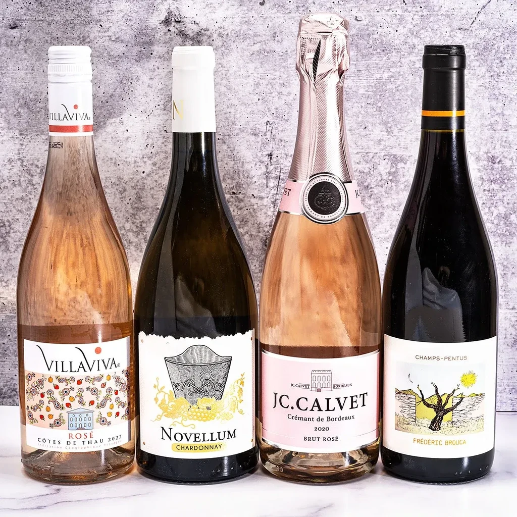 Four distinct bottles of rosé, white, sparkling rosé, and red wine.