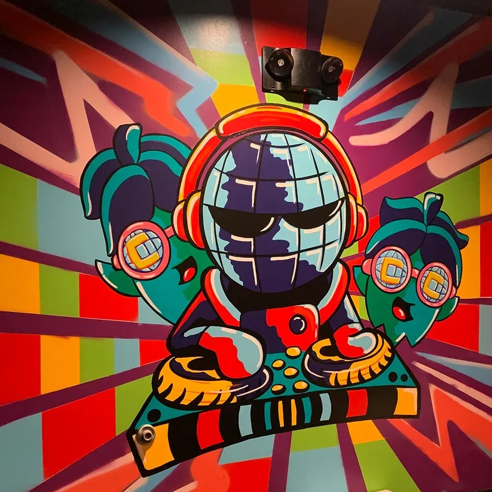 Colorful pop-art mural: globe DJ, two fruit characters, abstract background.