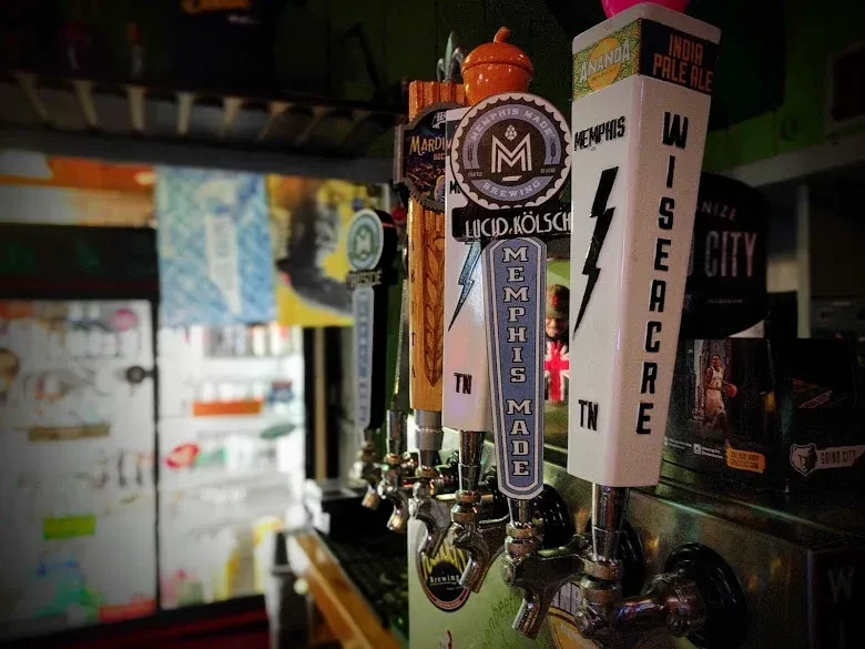 Row of beer tap handles featuring Memphis Made and Lucid Kölsch.