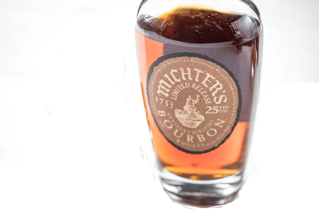 Bottle of Michter's 25 Year Old Bourbon Whiskey on white background.