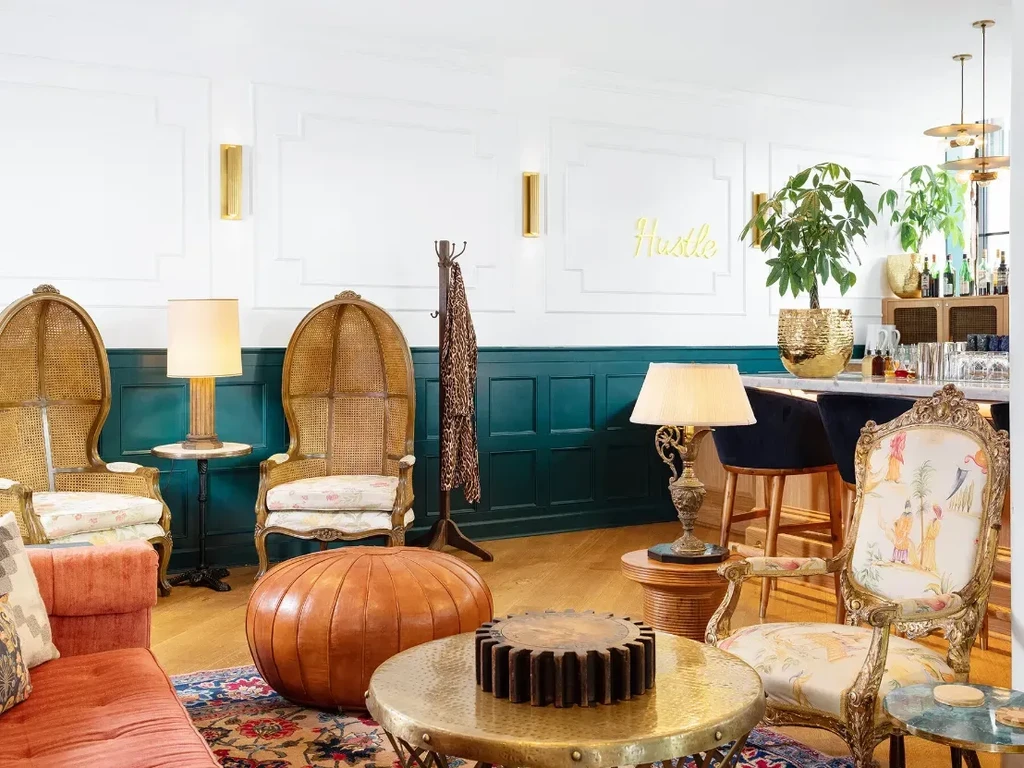 Eclectic vintage lounge interior with bar and 'Hustle' script.